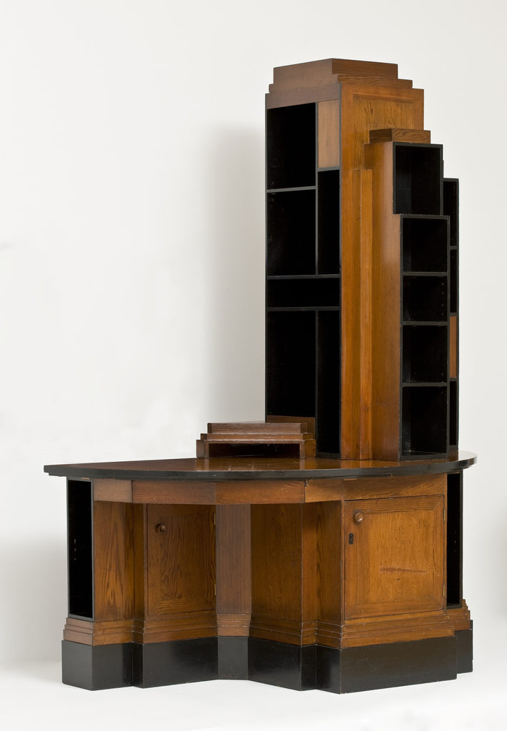 This is a Skyscraper Bookcase Desk. It was designed by Paul T. Frankl. It is dated ca. 1928. Its medium is california redwood and black laquer.